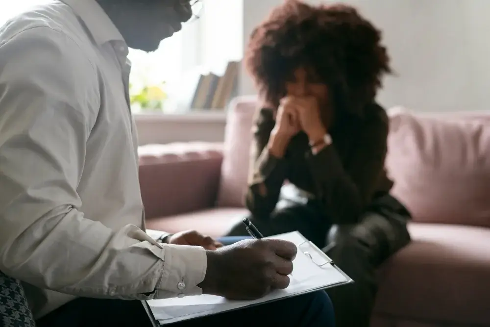 2151074002 Person receiving support from a professional counselor for hoarding issues.