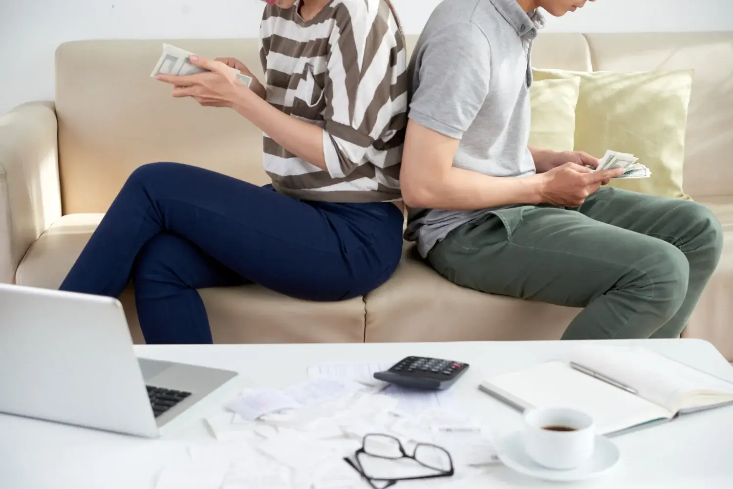 Man and woman sitting on a couch discussing counselling options in Calgary.