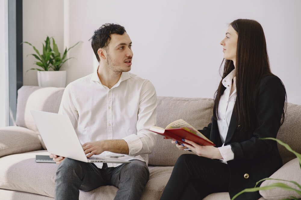 What to Expect in Your First Counselling Session | Epiphany Counselling A person sitting comfortably in a counselling office, speaking with a therapist in a calm and supportive setting during their first session.