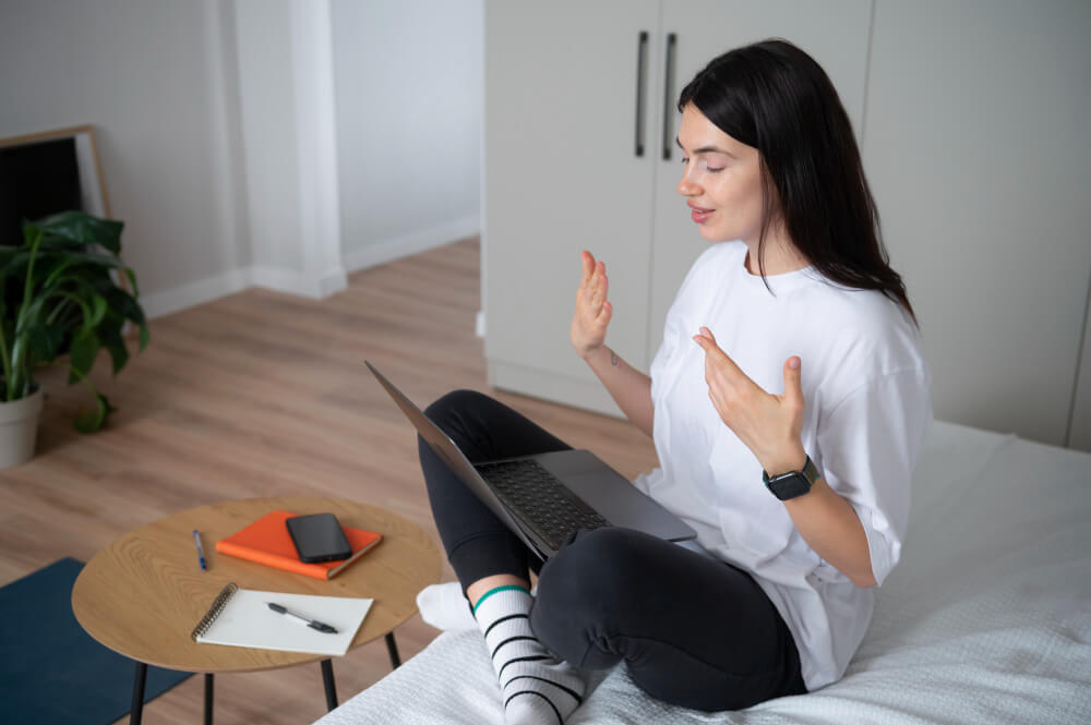How Online Therapy Works – Epiphany Counselling Person attending an online therapy session on a laptop in a private, comfortable home setting.